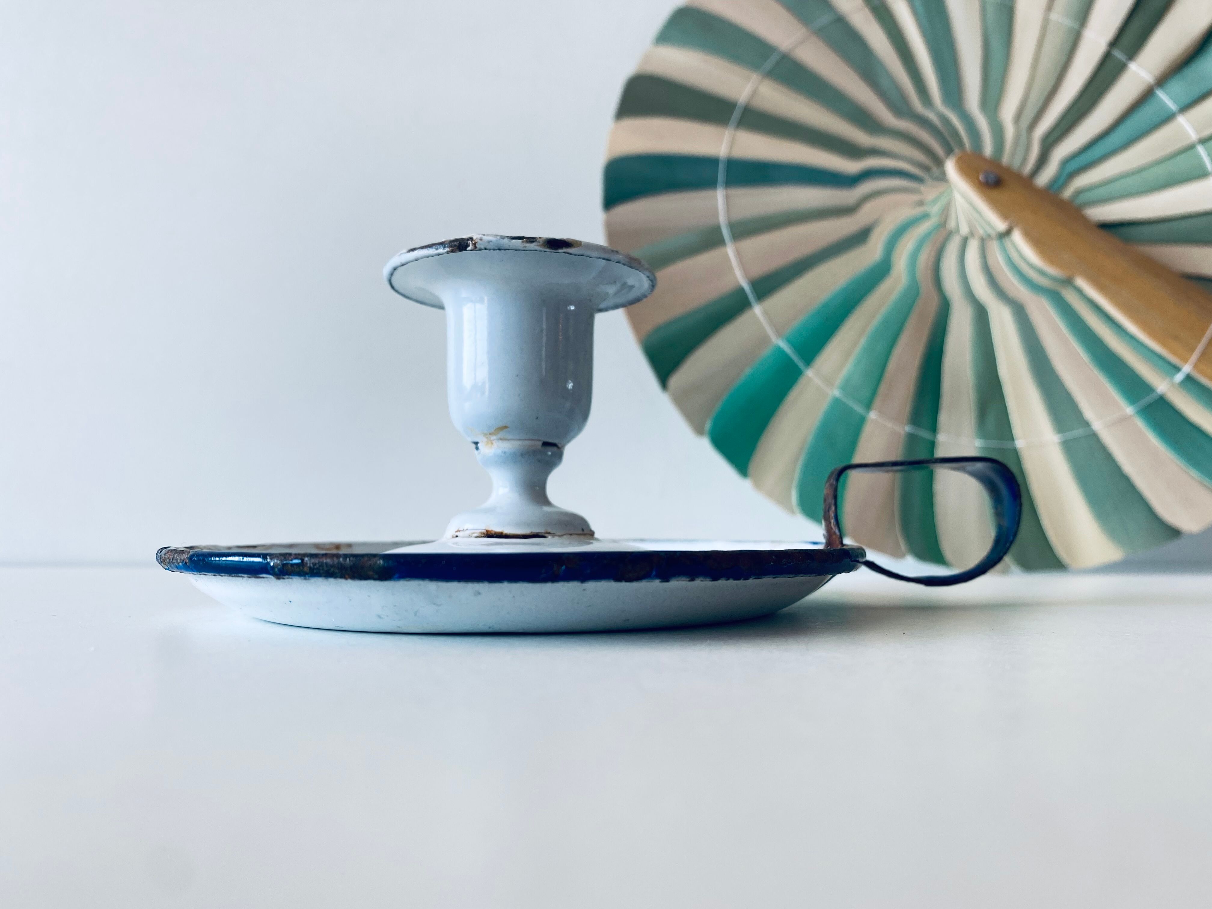 Antique candle holder in white and blue enamelled metal