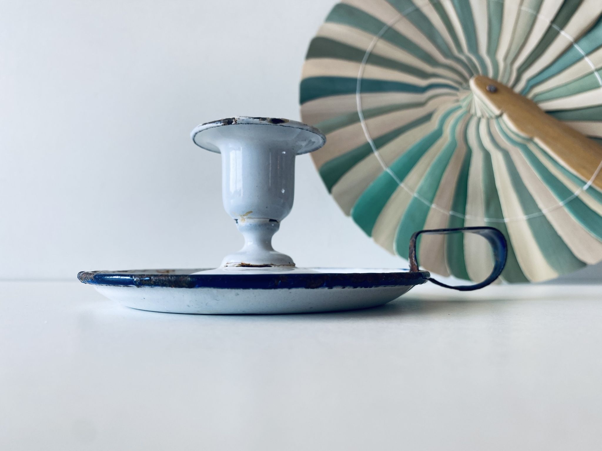 Antique candle holder in white and blue enamelled metal