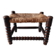 Antique wooden turned spool footrest with straw.