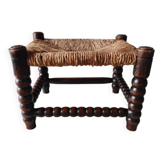 Antique turned wood footrest with bobbin and straw.