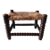 Antique wooden turned spool footrest with straw.