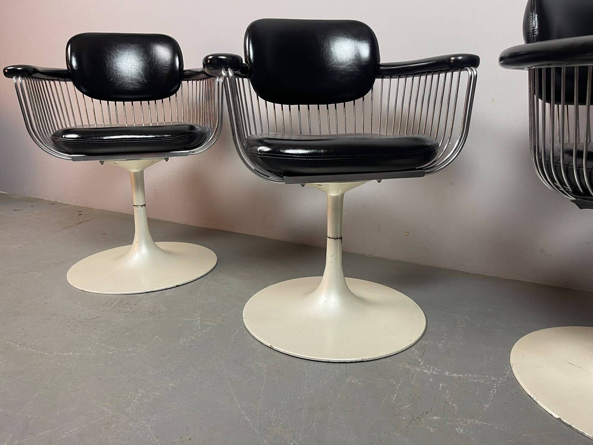 A striking set of four vintage swivel dining chairs