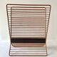 Wire metal magazine rack with triangular compartment, 1950s.