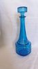 Turquoise glass carafe bottle with a stopper.