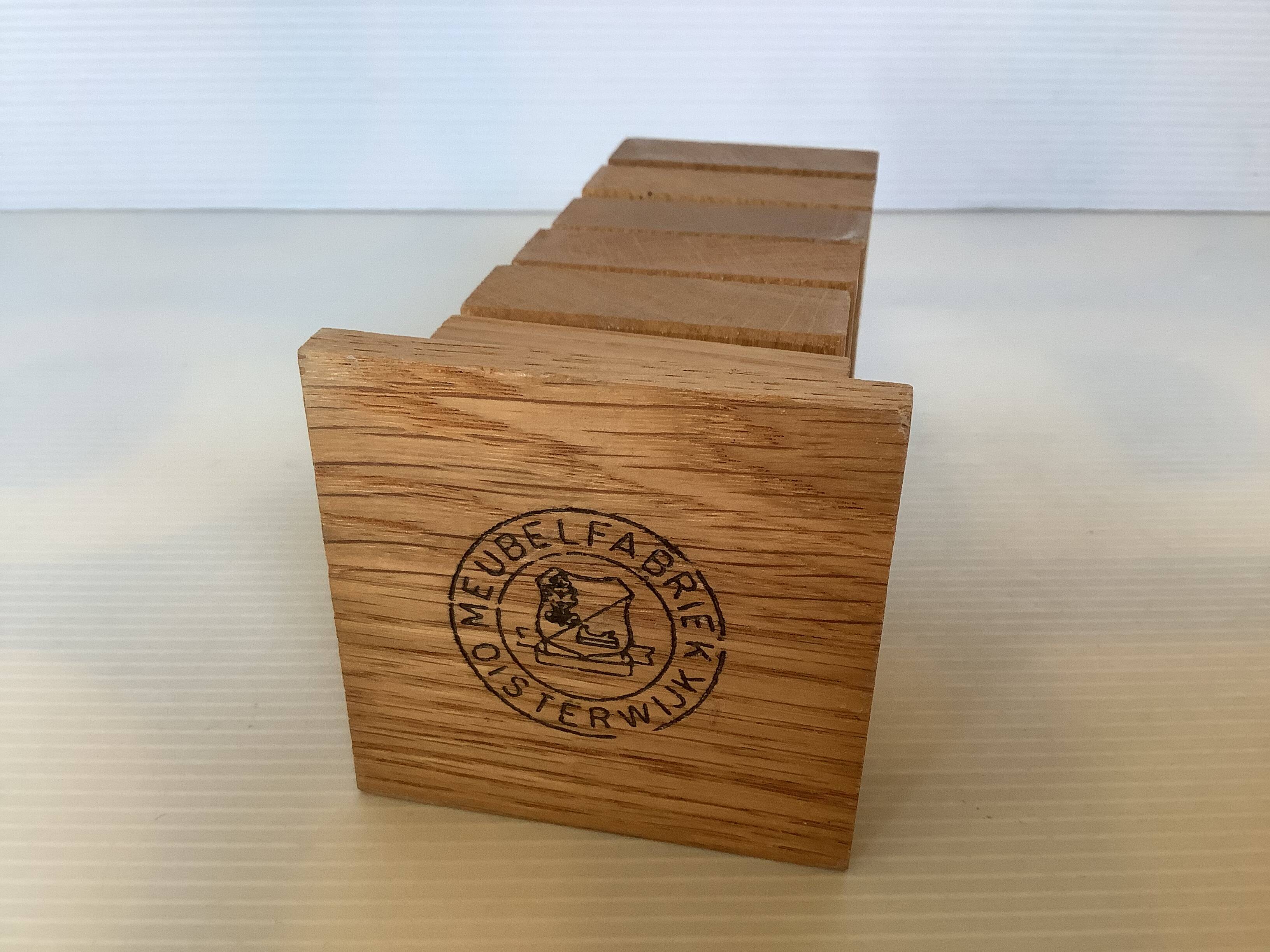 Six wooden egg cups and their Scandinavian style support