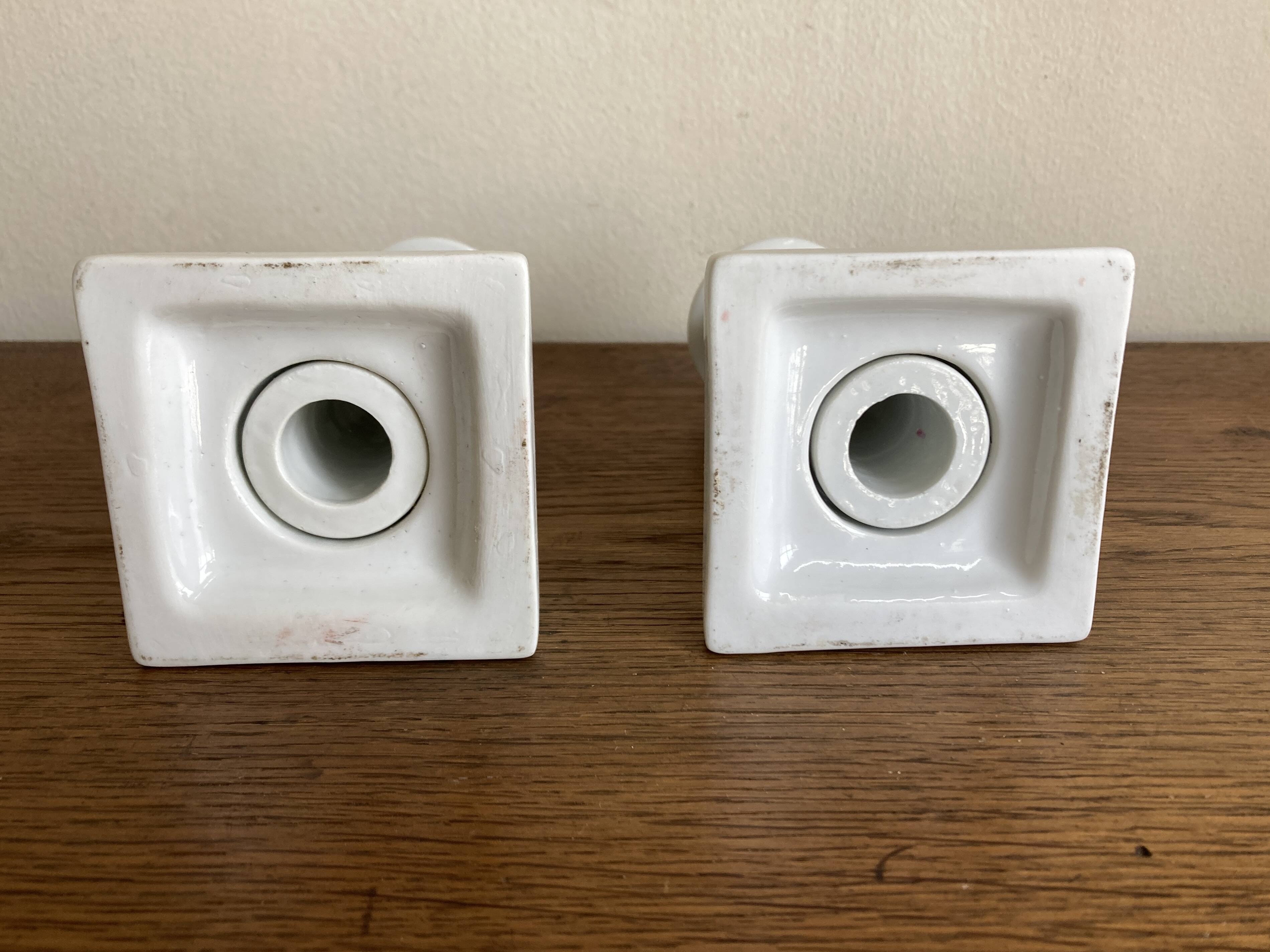 Pair of neo-classical Empire candlesticks from the late 19th century in white porcelain.