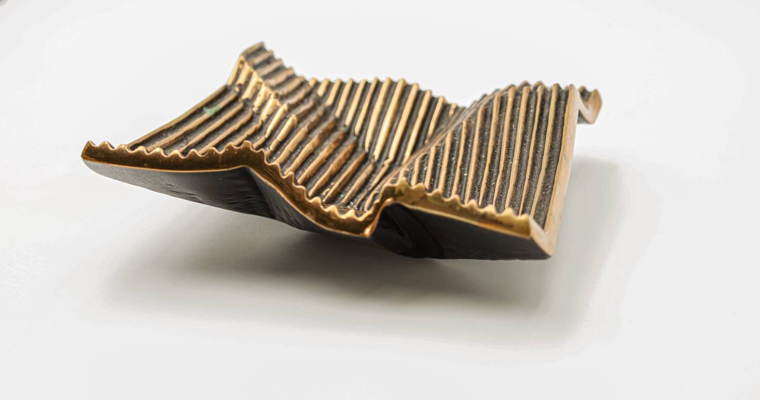 Brutalist bronze pocket emptier