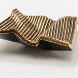 Brutalist bronze pocket emptier