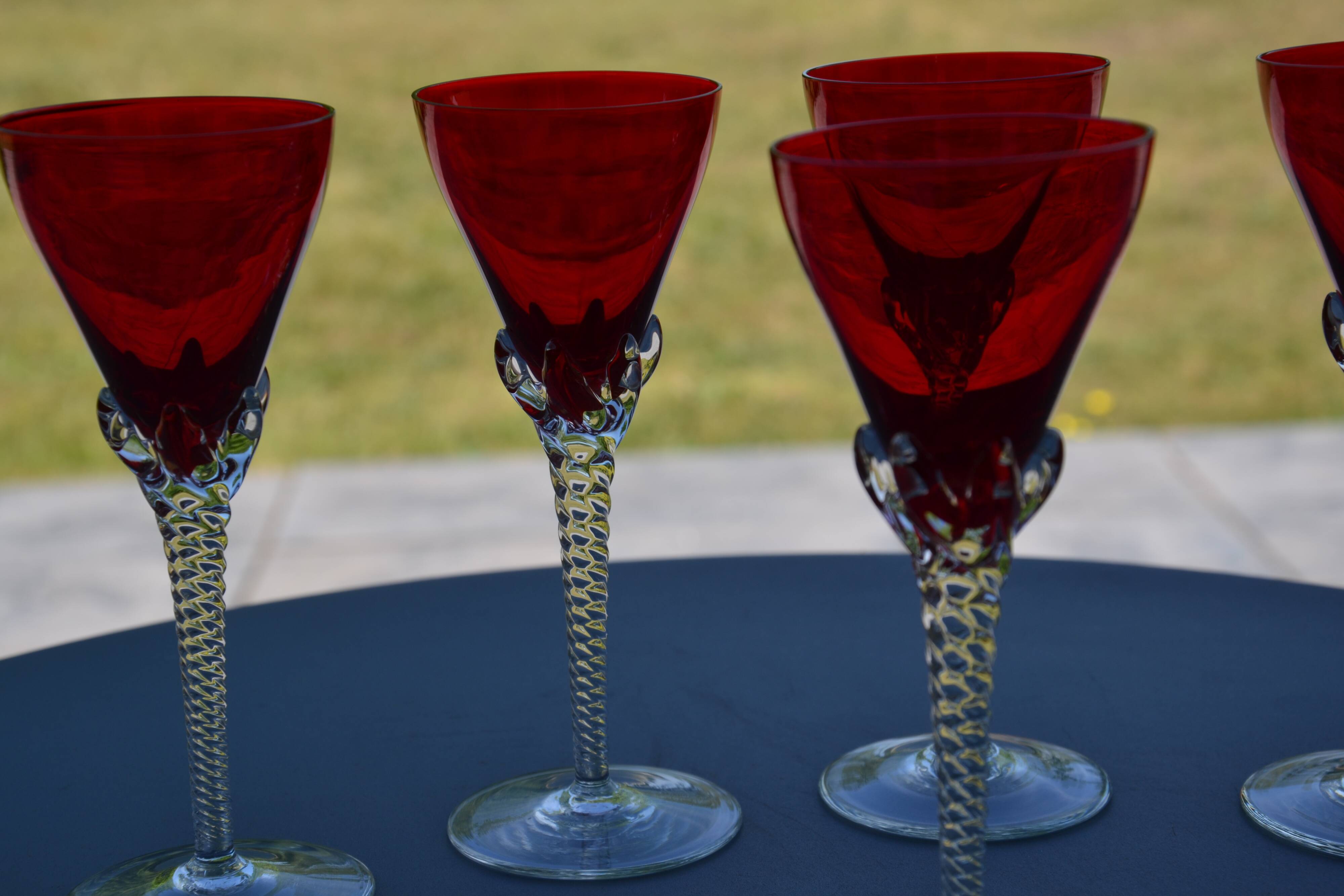5 red crystal glasses with twisted stems
