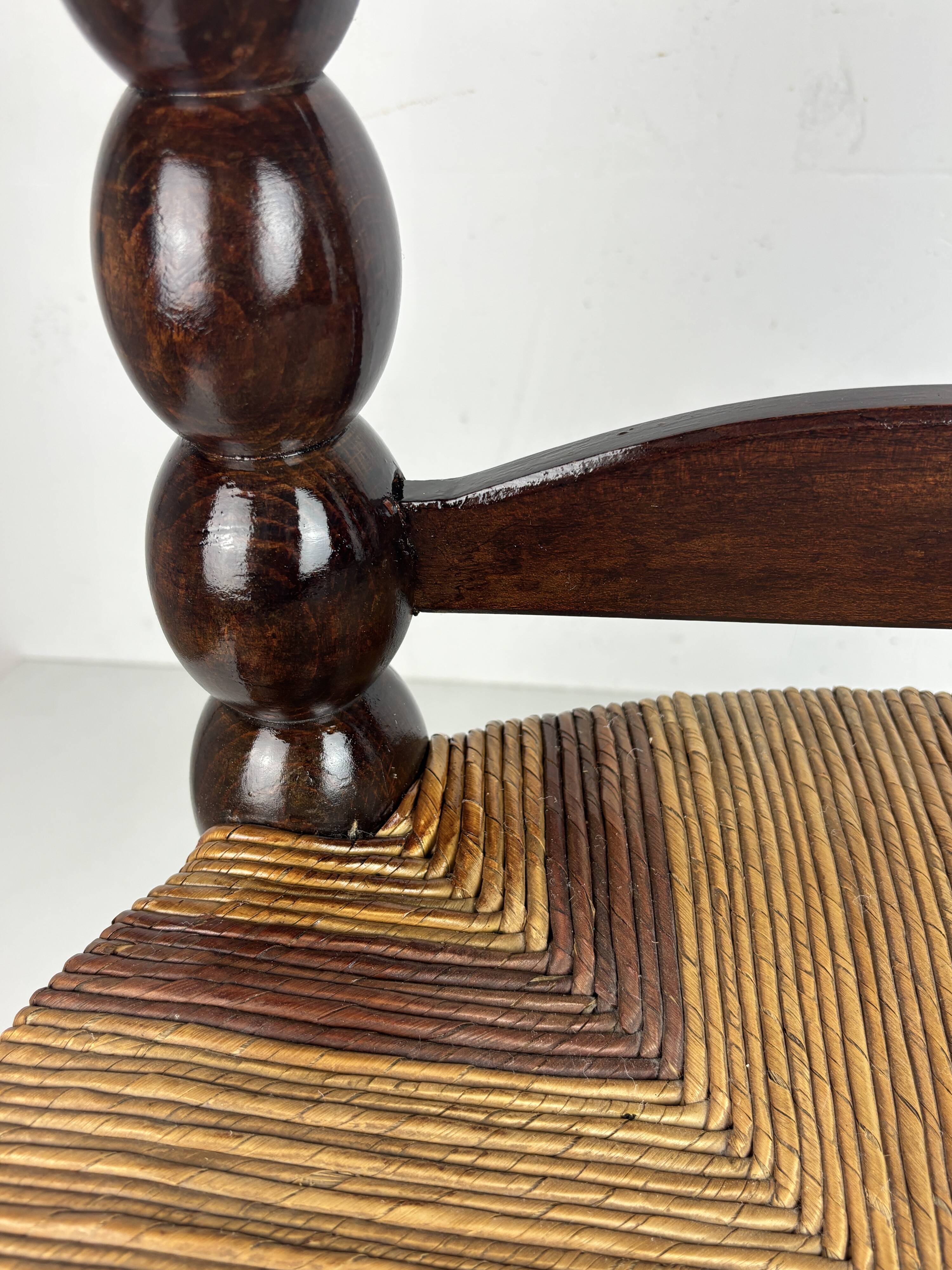 Brutalist wood turned bobbin low rush chair n the style of Charles Dudouyt