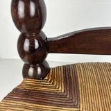 Brutalist wood turned bobbin low rush chair n the style of Charles Dudouyt