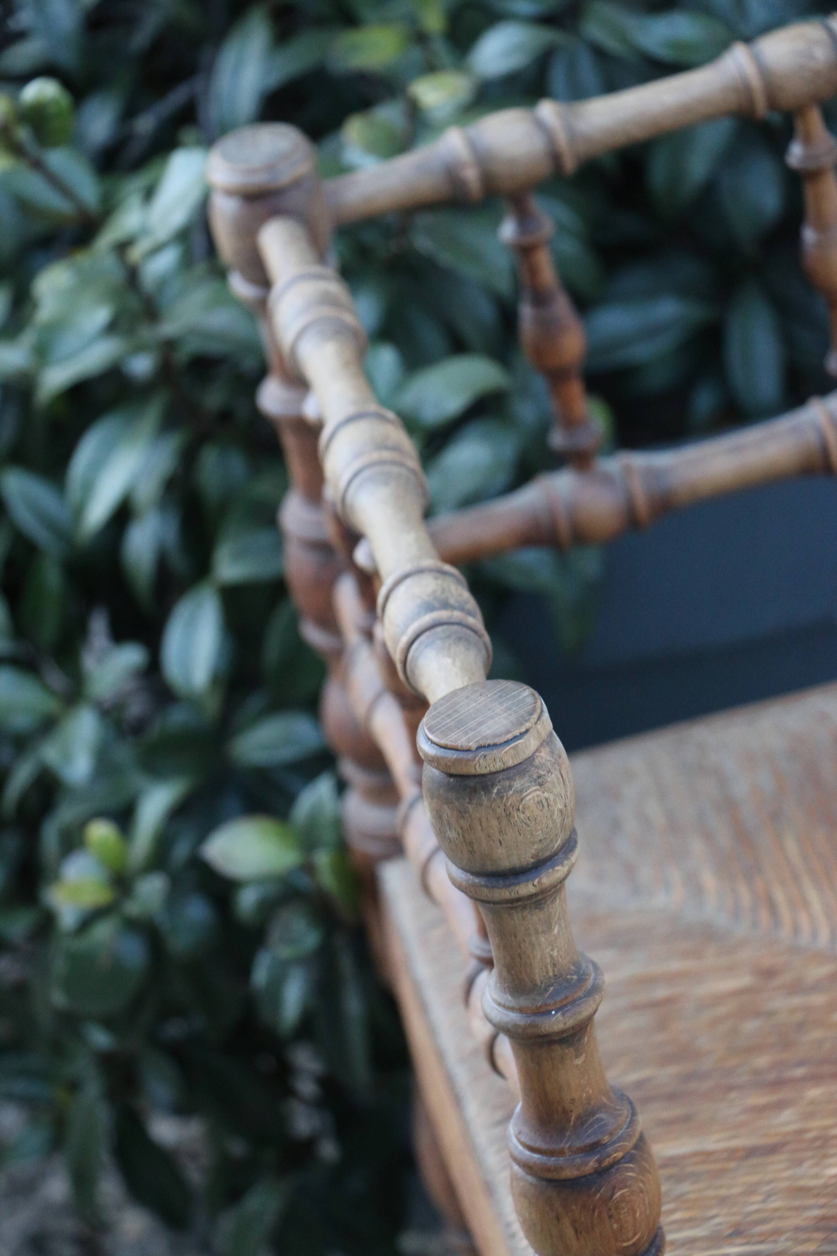 Antique corner chair in wood bamboo style seated in straw
