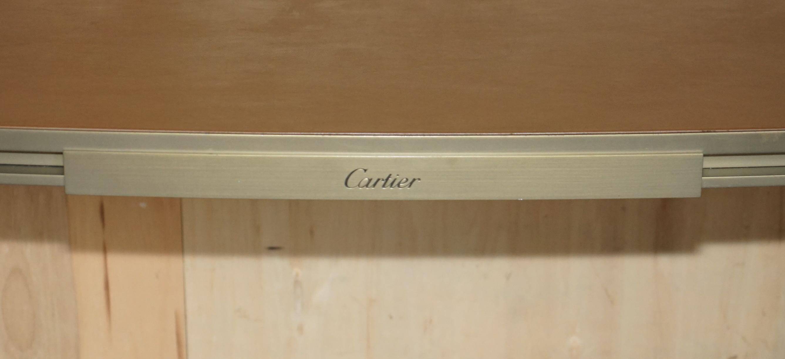 Modern mid-century writing desk signed Cartier in bronze and leather.