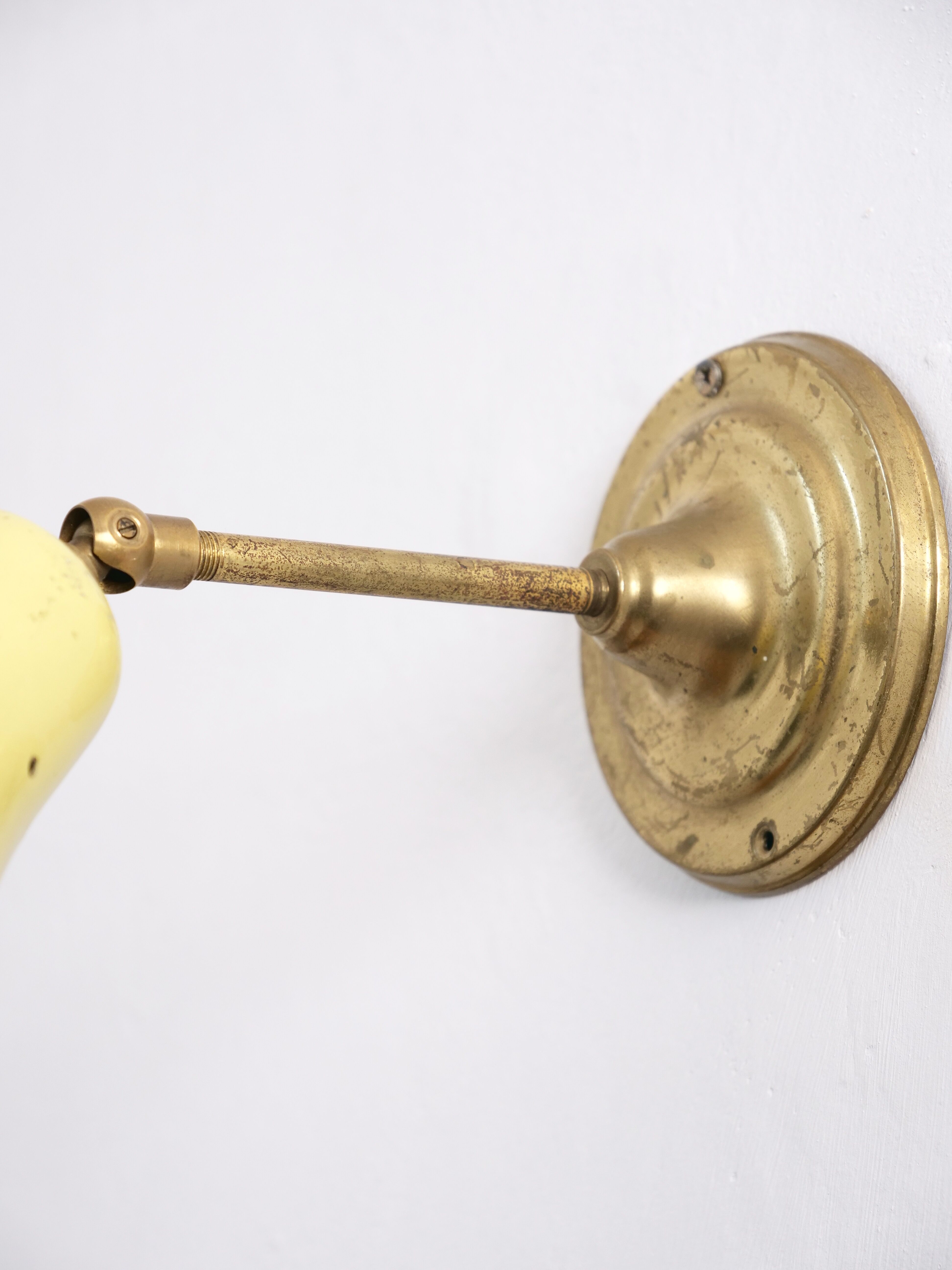 Wall lamp inlaiton and pale yellow lacquered metal
