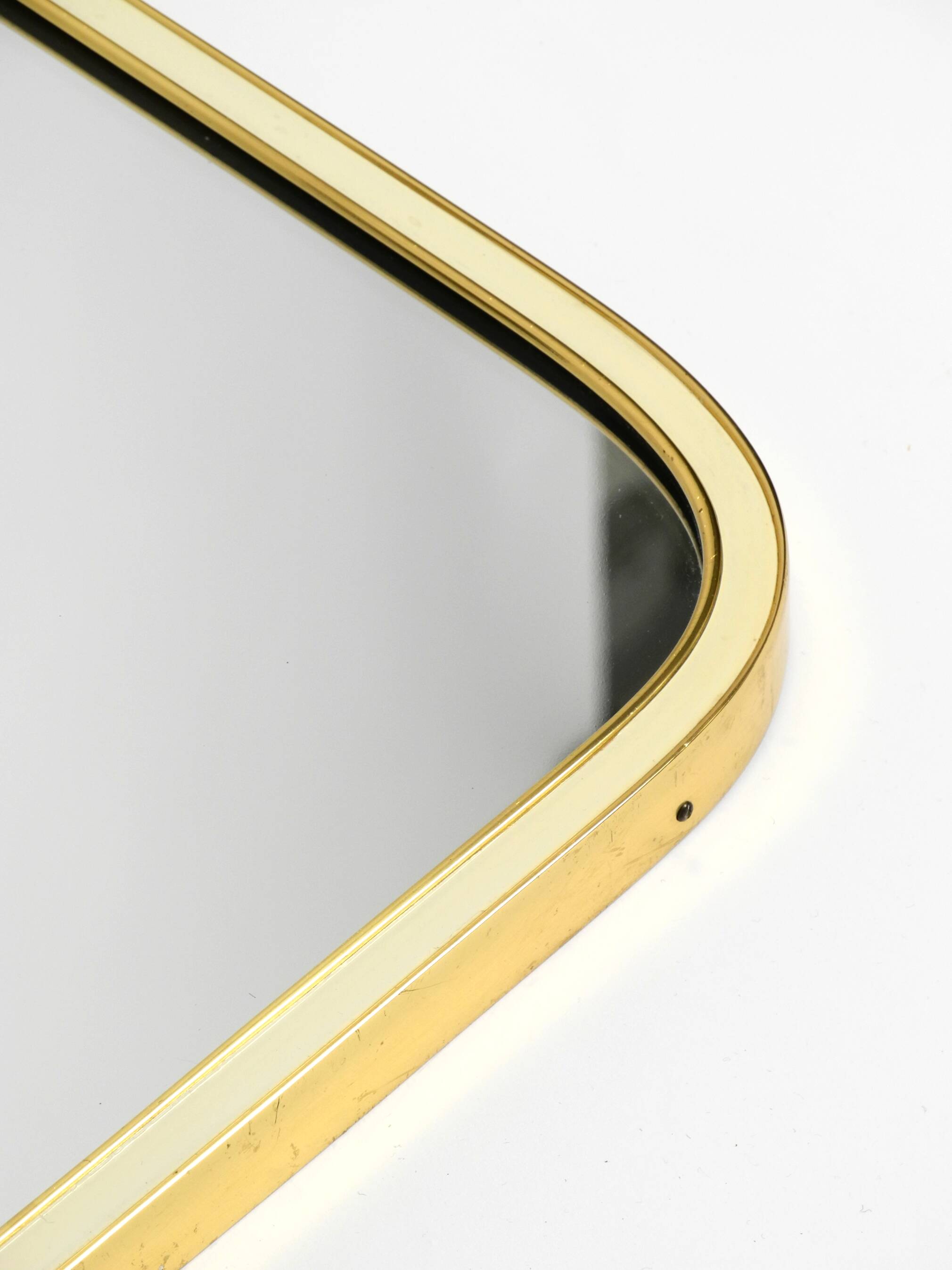 Large heavy long Mid Century brass wall mirror by Münchner Zierspiegel