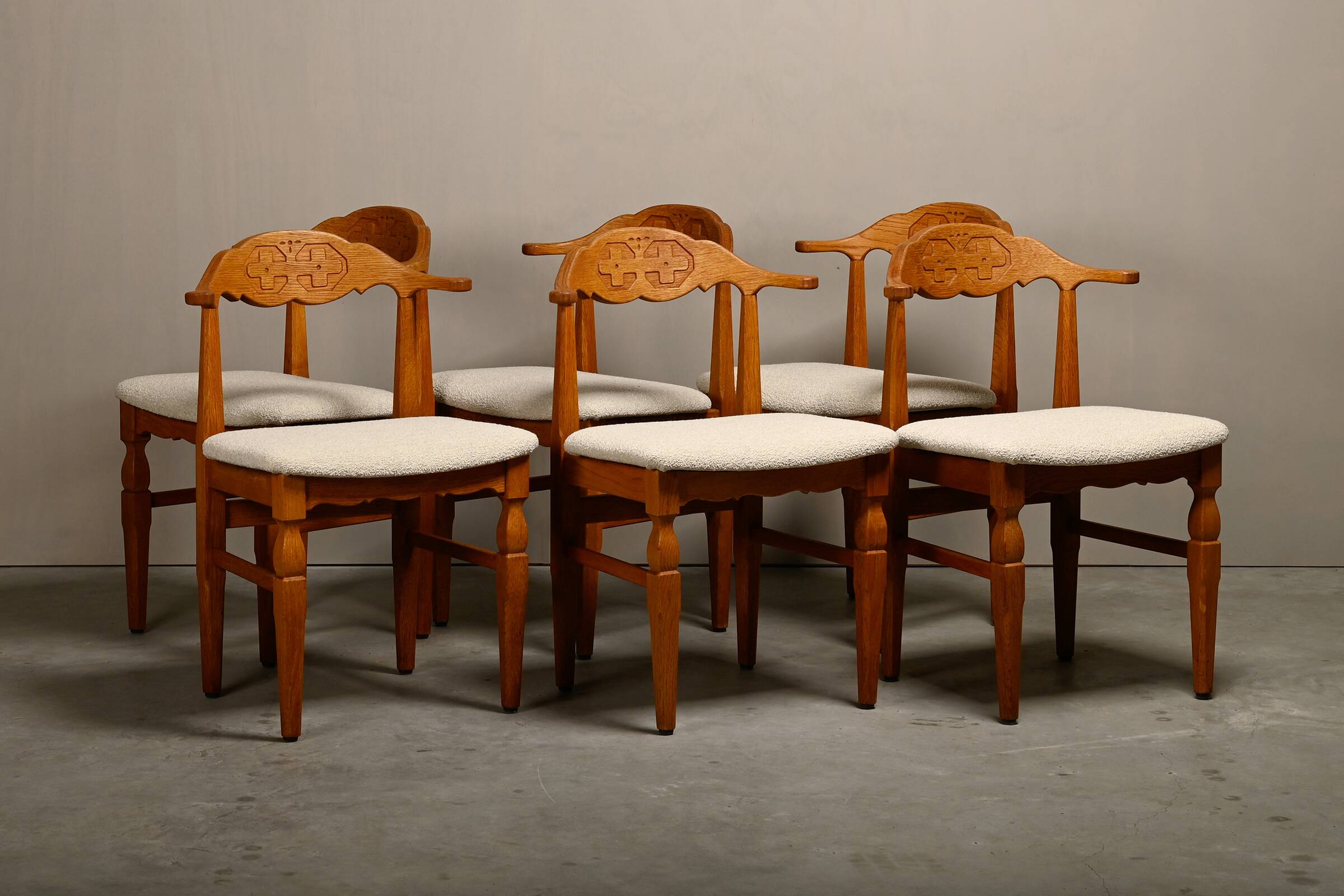Henning Kjærnulf dining chairs set in Oak and Off White Bouclé, Denmark, 1960s