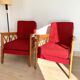 Pair of vintage wooden armchairs with braces