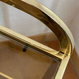 Gold metal and smoked glass console table.