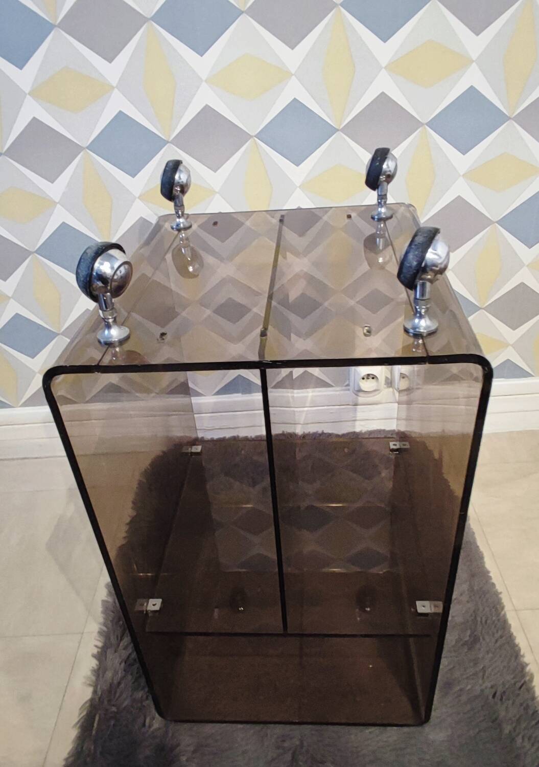 Michel Dumas smoked Plexiglas rolling table.