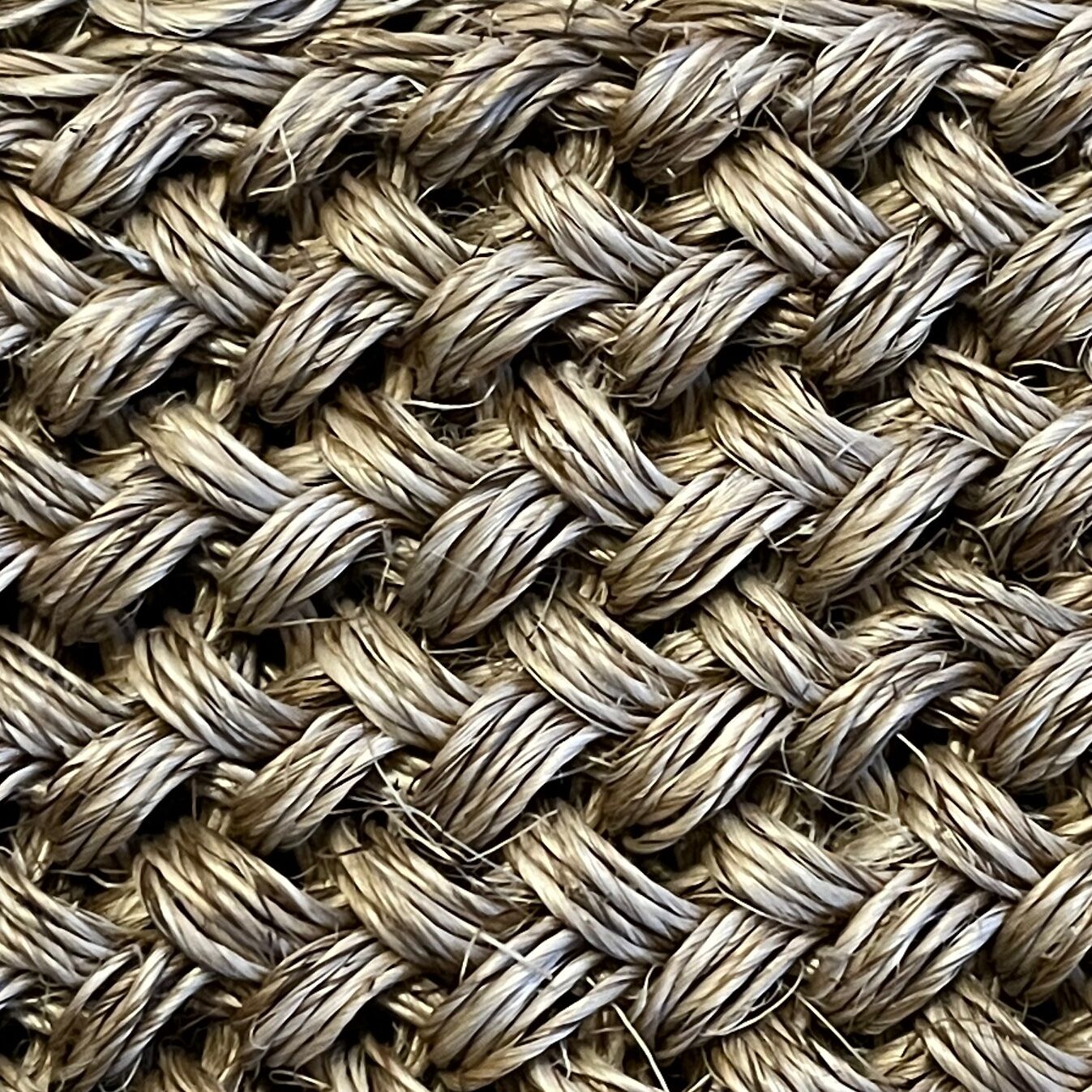 Handmade carpet in natural fiber of knitted palm leaf