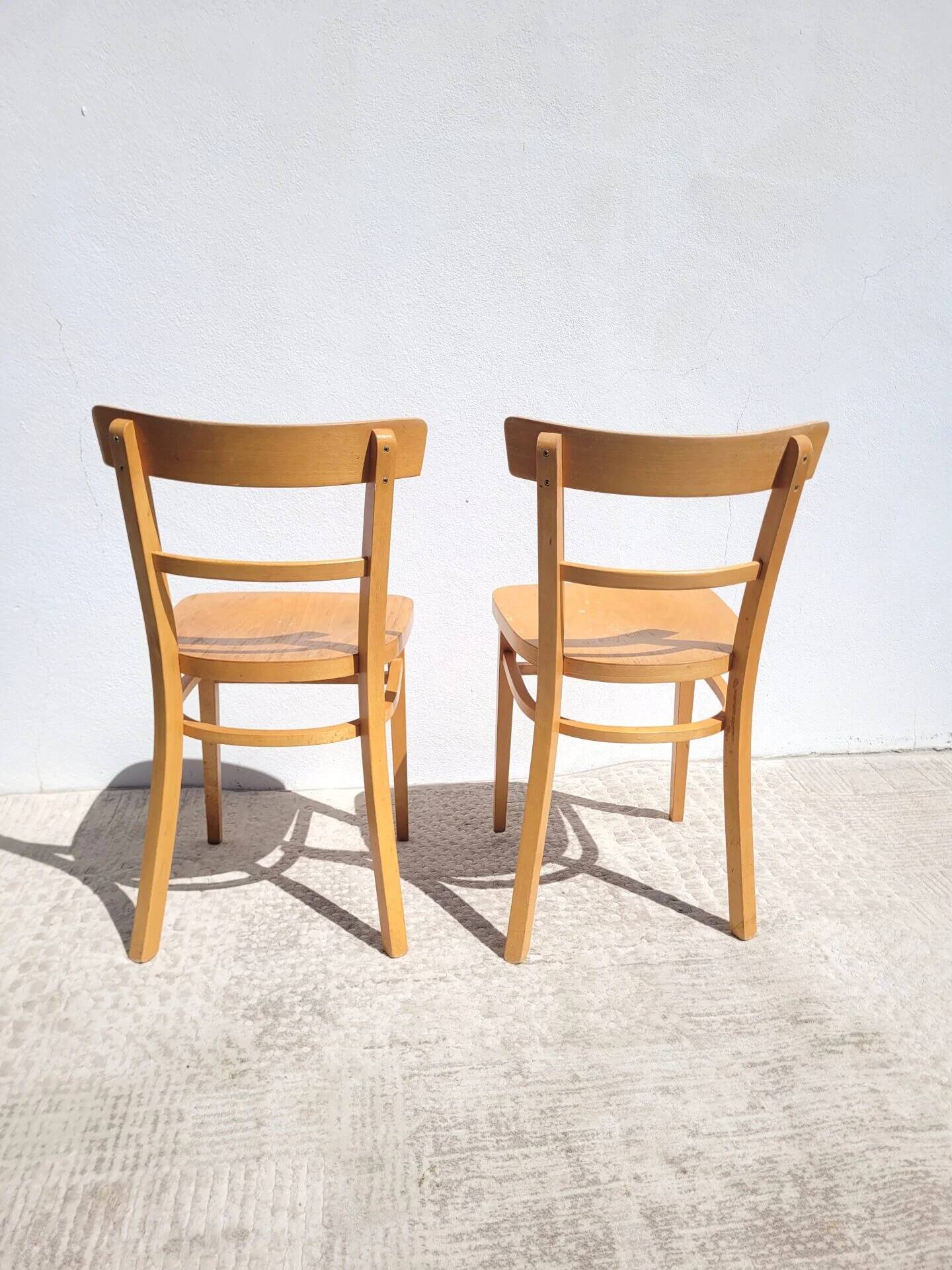 Pair of bistro chairs in light beech.