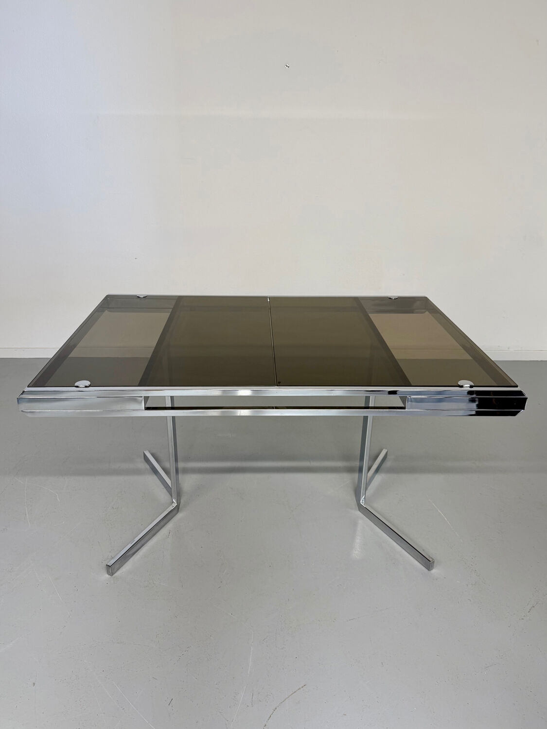 Smoked glass dining table with chrome legs, 1970s design by Roche Bobois.