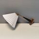 Wall lamp with adjustable ‘arm’ in copper and rosewood, with white shade.