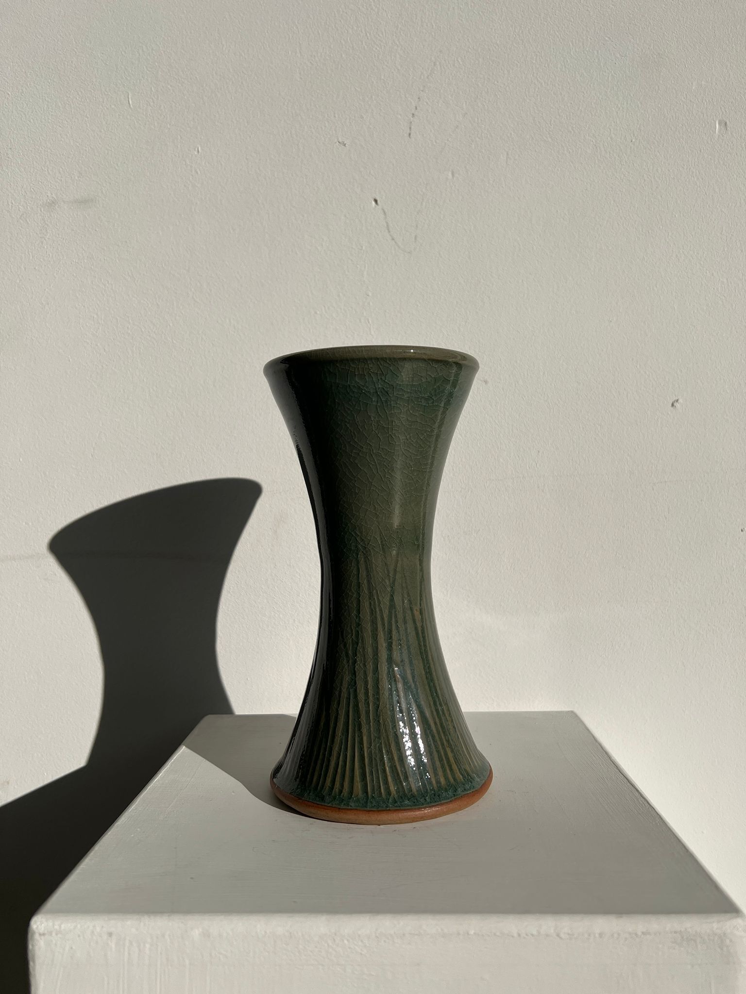 Dark green handcrafted vase with glazed ceramic grass blades