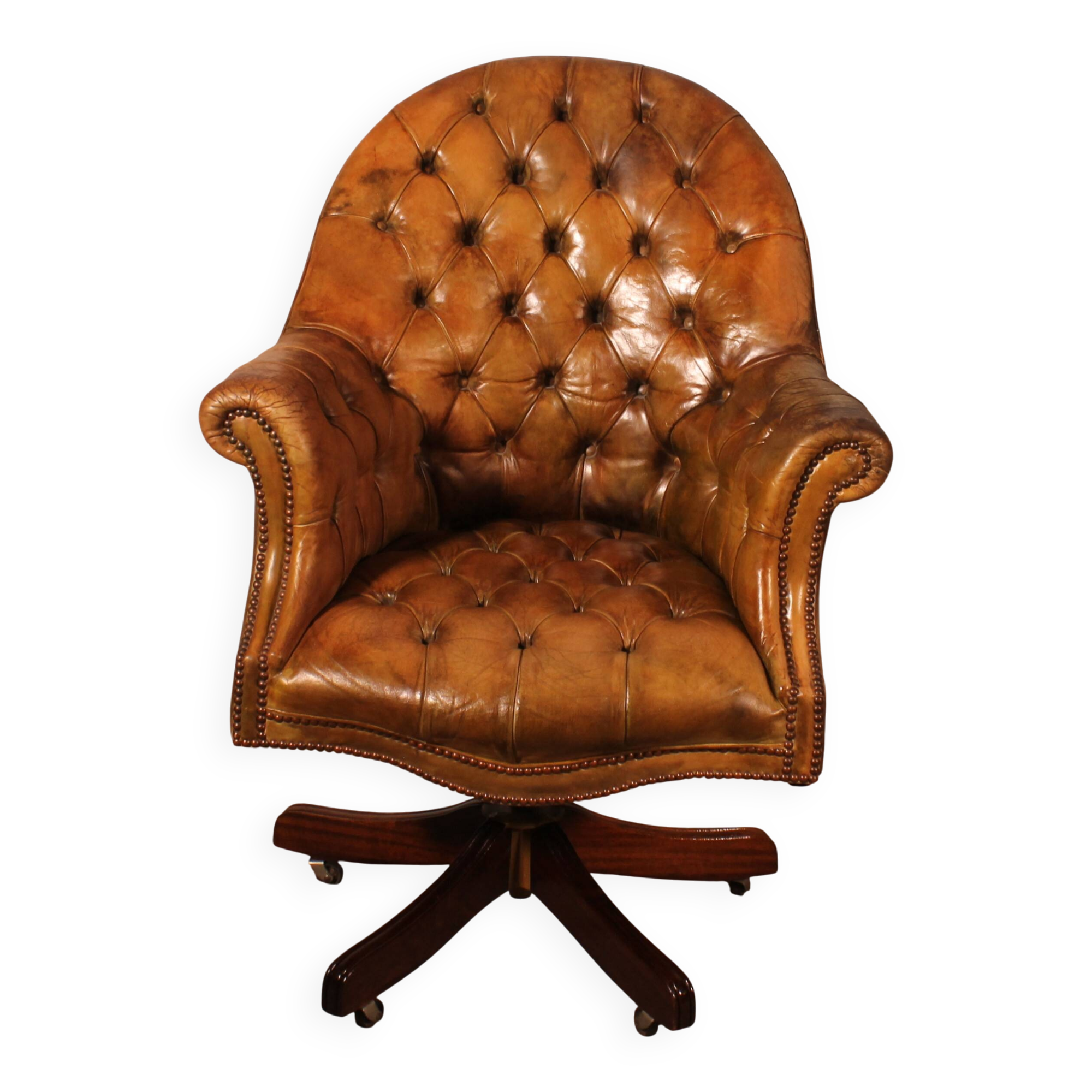 Office chair known as a presidential chair in mahogany and cognac leather.