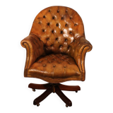 Office chair known as a presidential chair in mahogany and cognac leather.