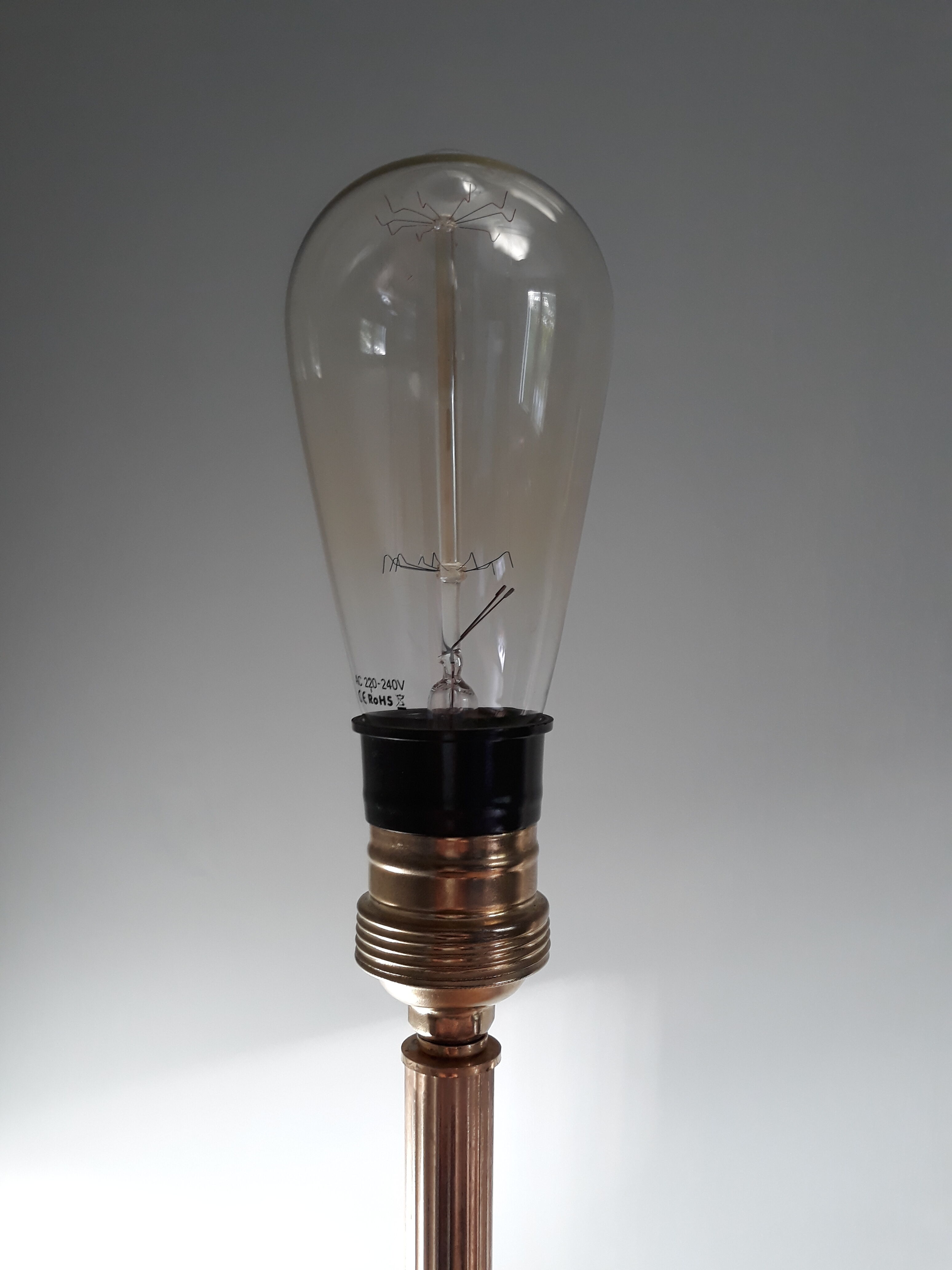 Golden and black tripod floor lamp