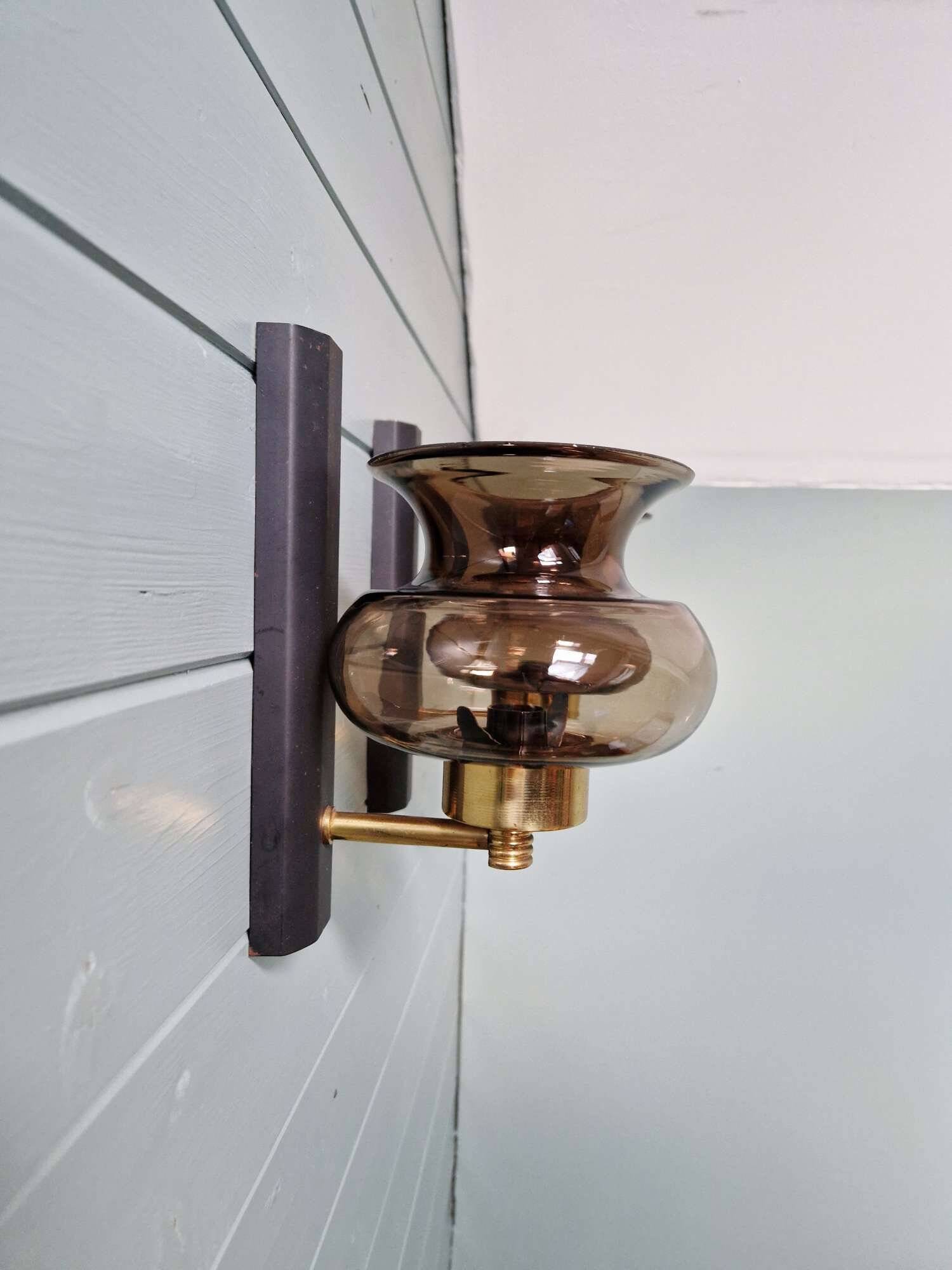 Pair of wall sconces in brass and smoked glass, 1960s.