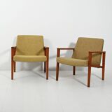 Pair of Danish teak armchairs with green upholstery