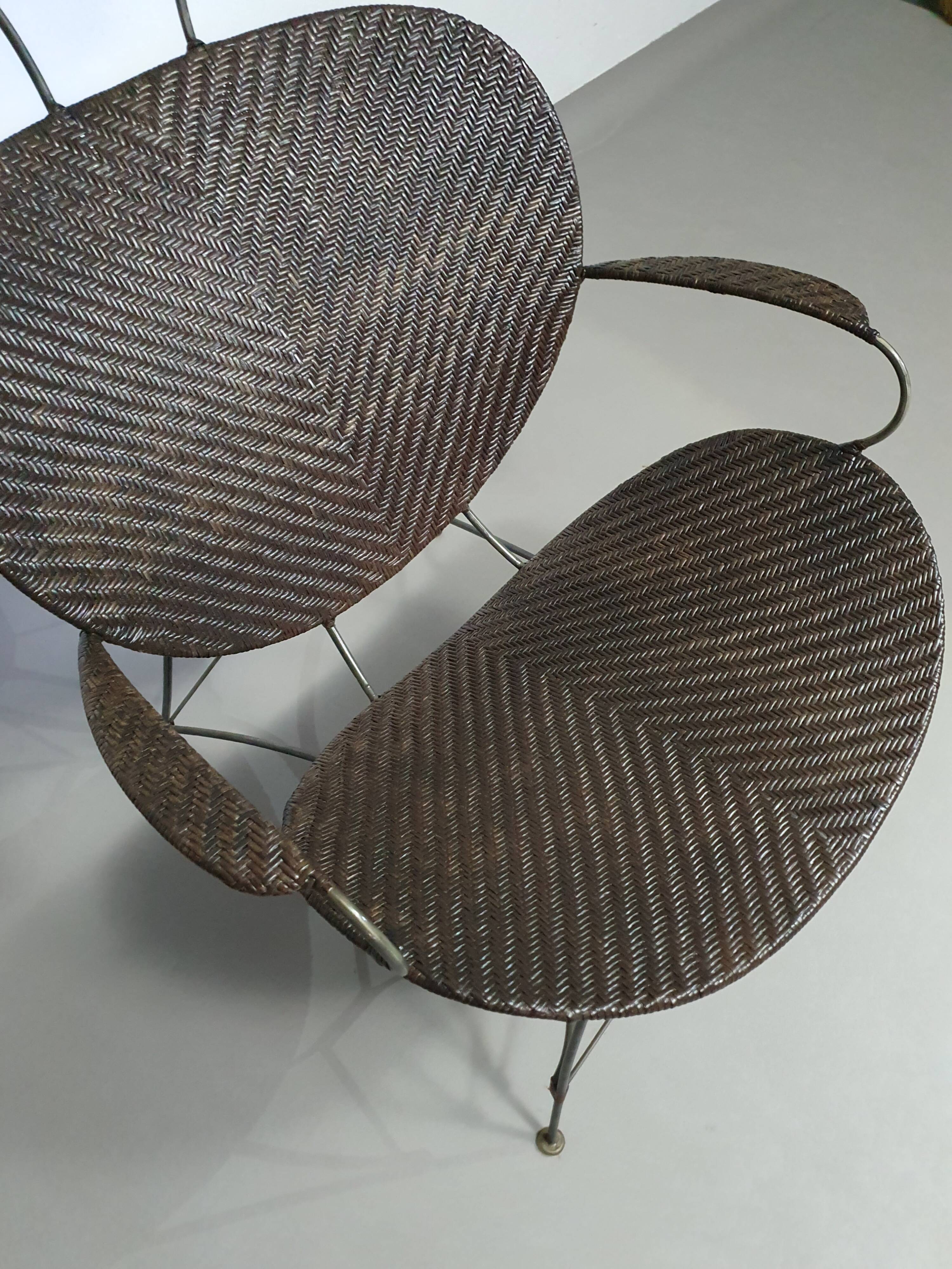 Armchair designed by Yuzuru Yamakawa  Metal frame.  Seat and back in braided rattan.