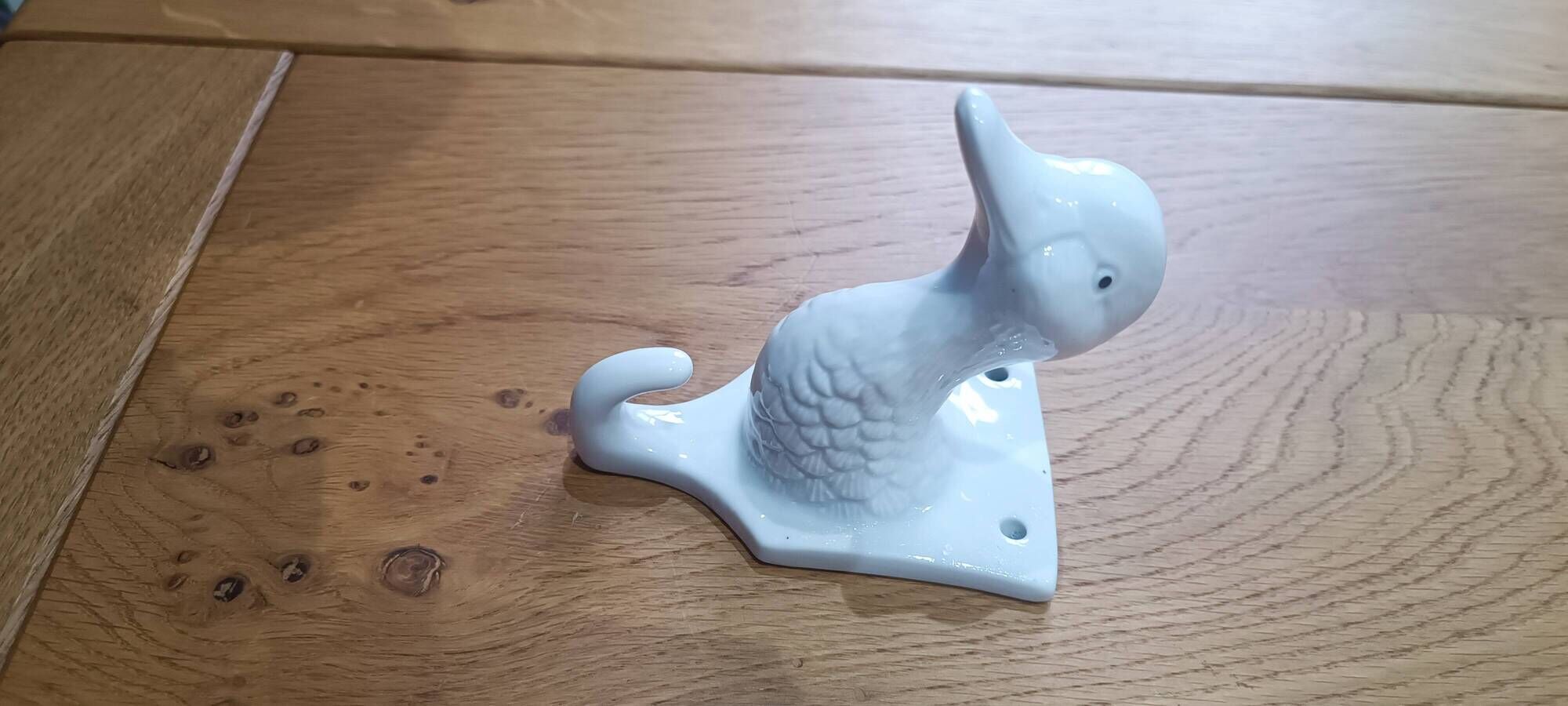 Wall-mounted duck head coat hook in white ceramic, cottagecore style.