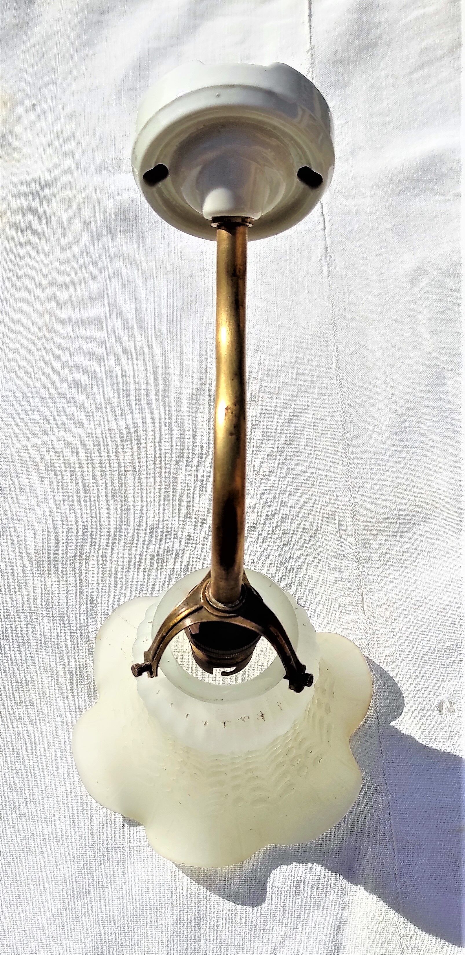 Brass gooseneck wall lamp, with brass socket and porcelain base.