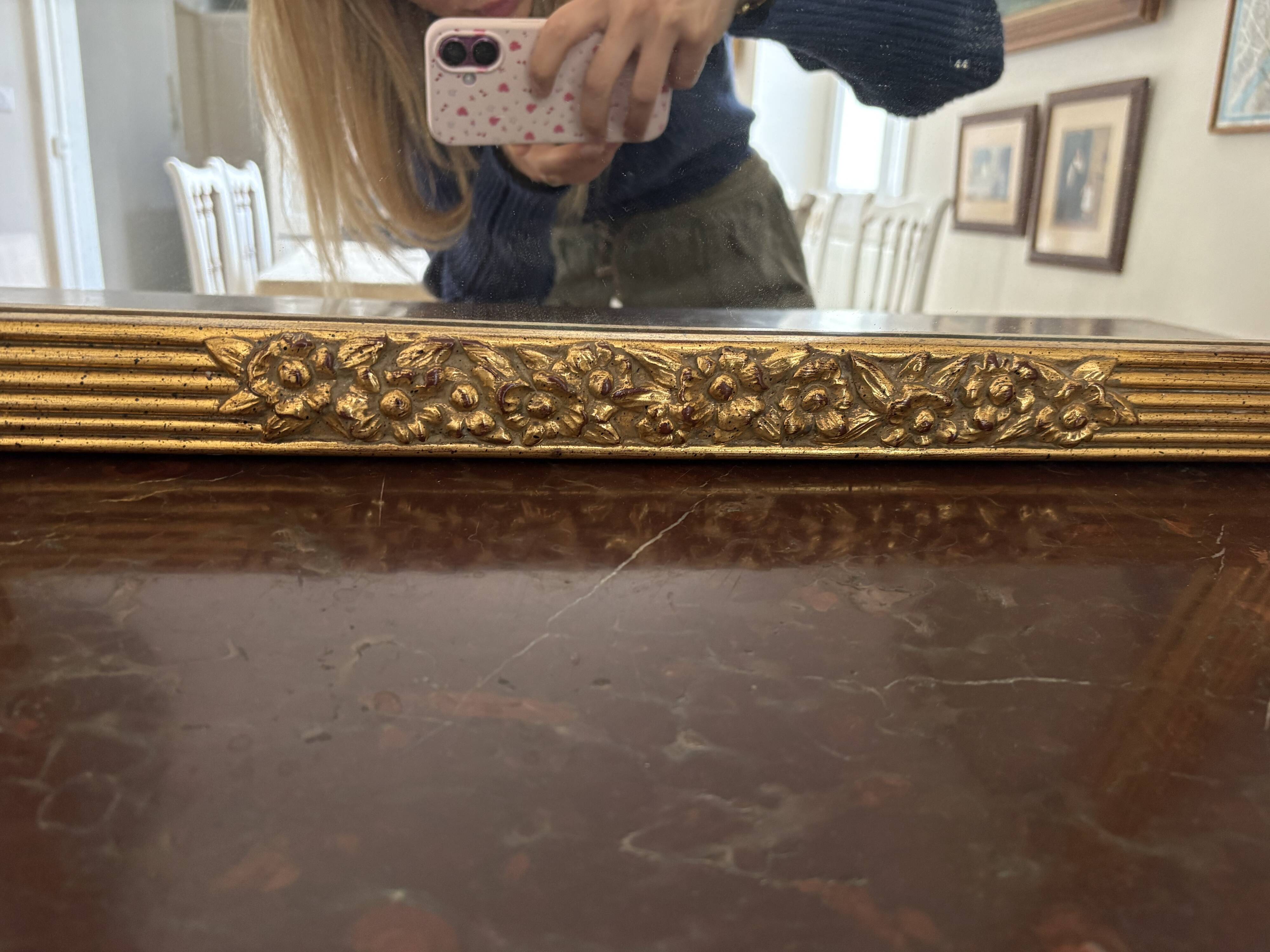 Large vintage gold mirror in Louis XVI style – fluted frame and floral decoration.