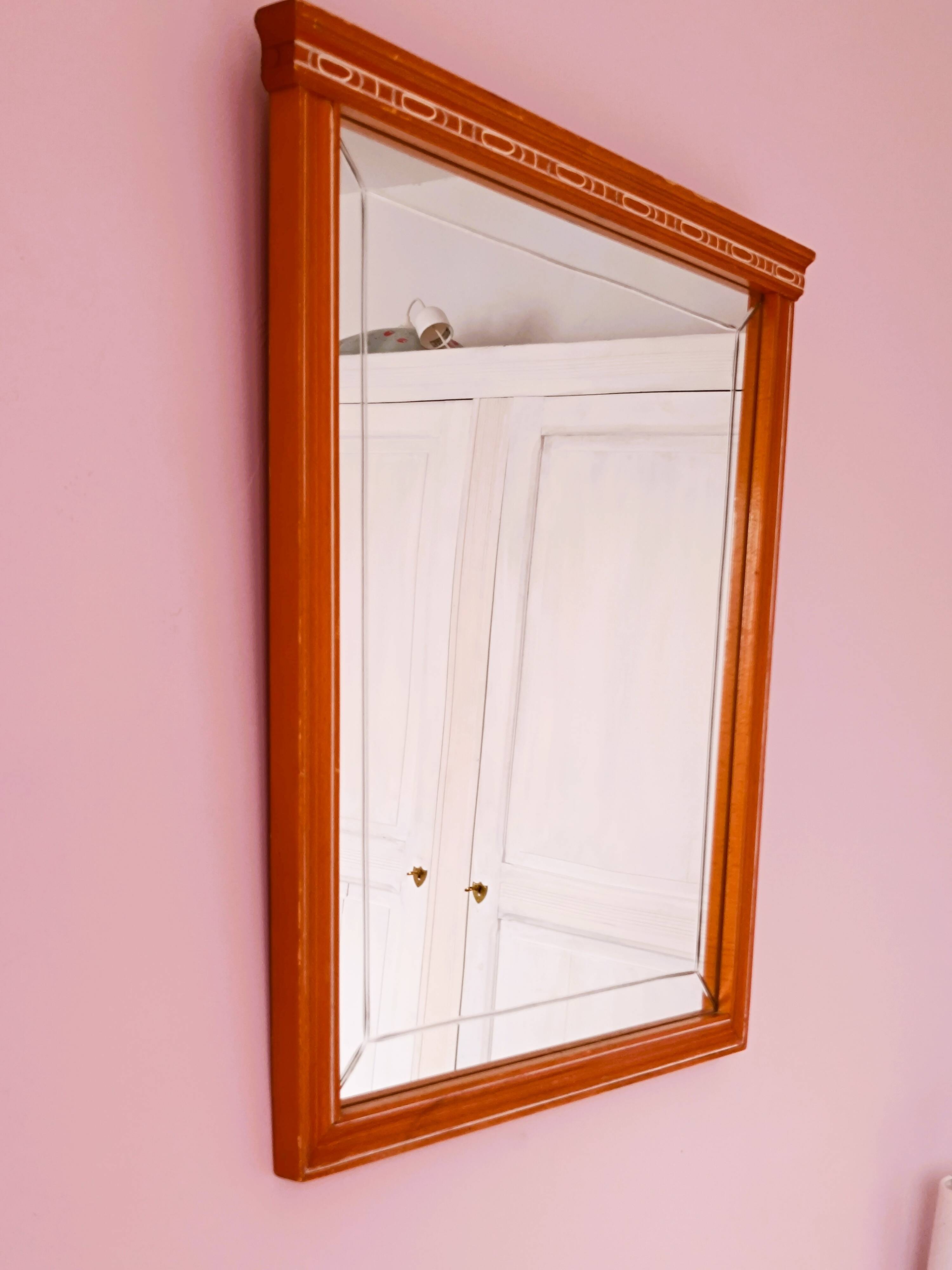 Beveled glass wall mirror in solid wood frame