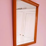 Beveled glass wall mirror in solid wood frame