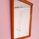 Beveled glass wall mirror in solid wood frame