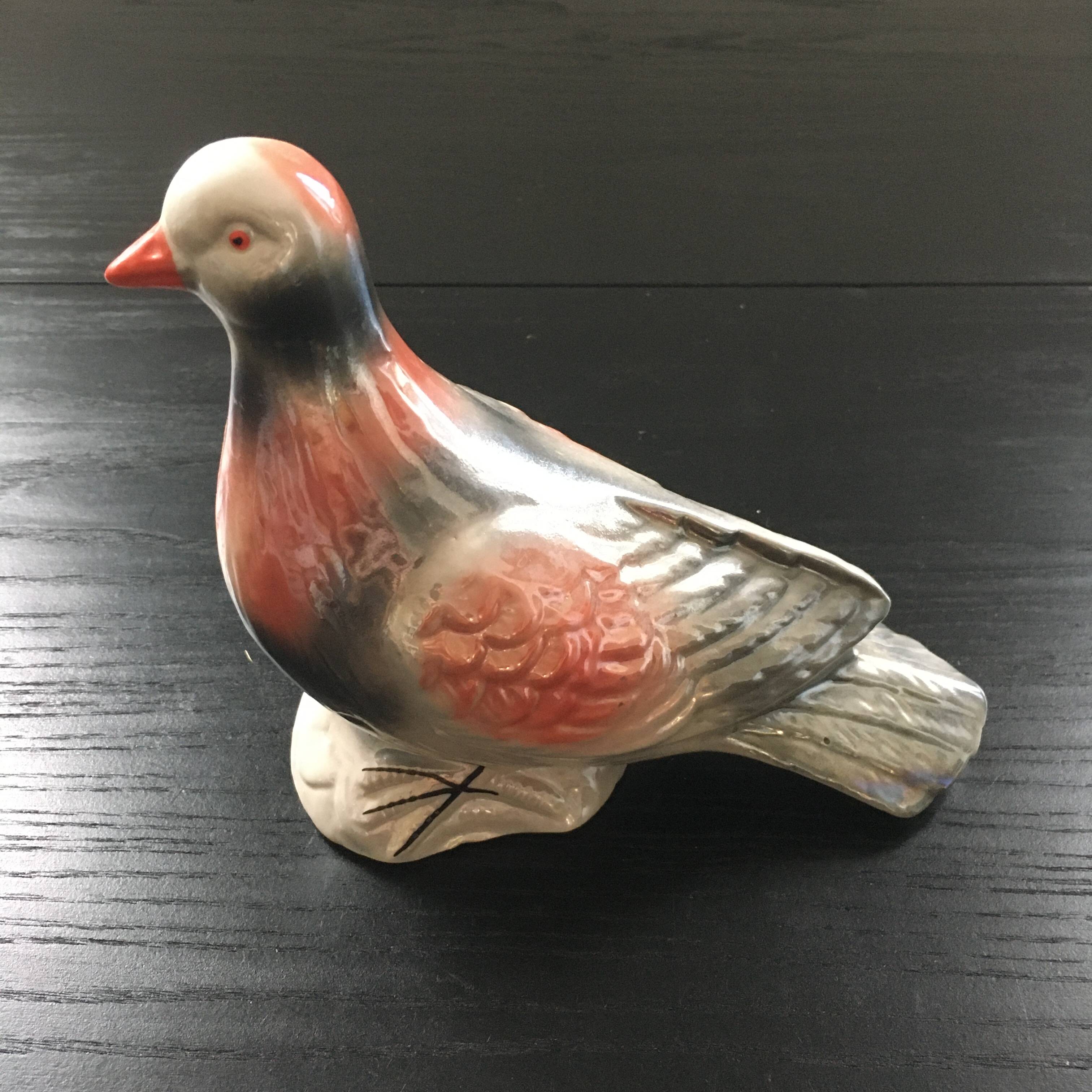 Antique bird in pearly ceramic