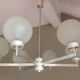 Six-light chrome metal chandelier and opaque glass globes / vintage 60s and 70s