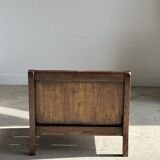 Small low armchair in varnished brown wood