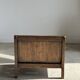 Small low armchair in varnished brown wood