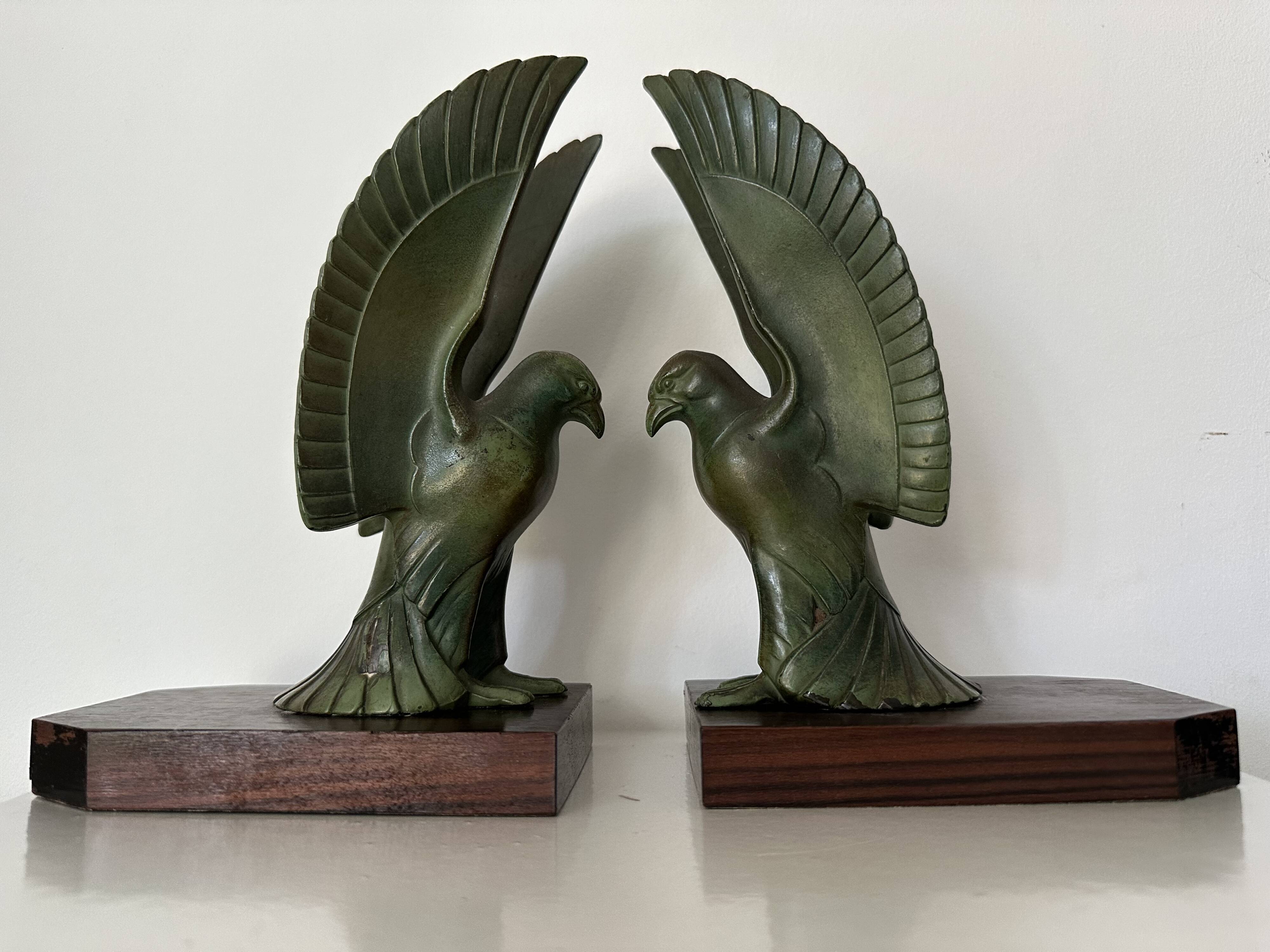 Pair of eagle bookends in green patina regula with rosewood base