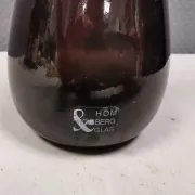A unique vase in hand-blown glass with a hint of purple in the colour.