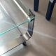 Brushed chrome coffee table with glass, 2 tiers on wheels, 1970s design.