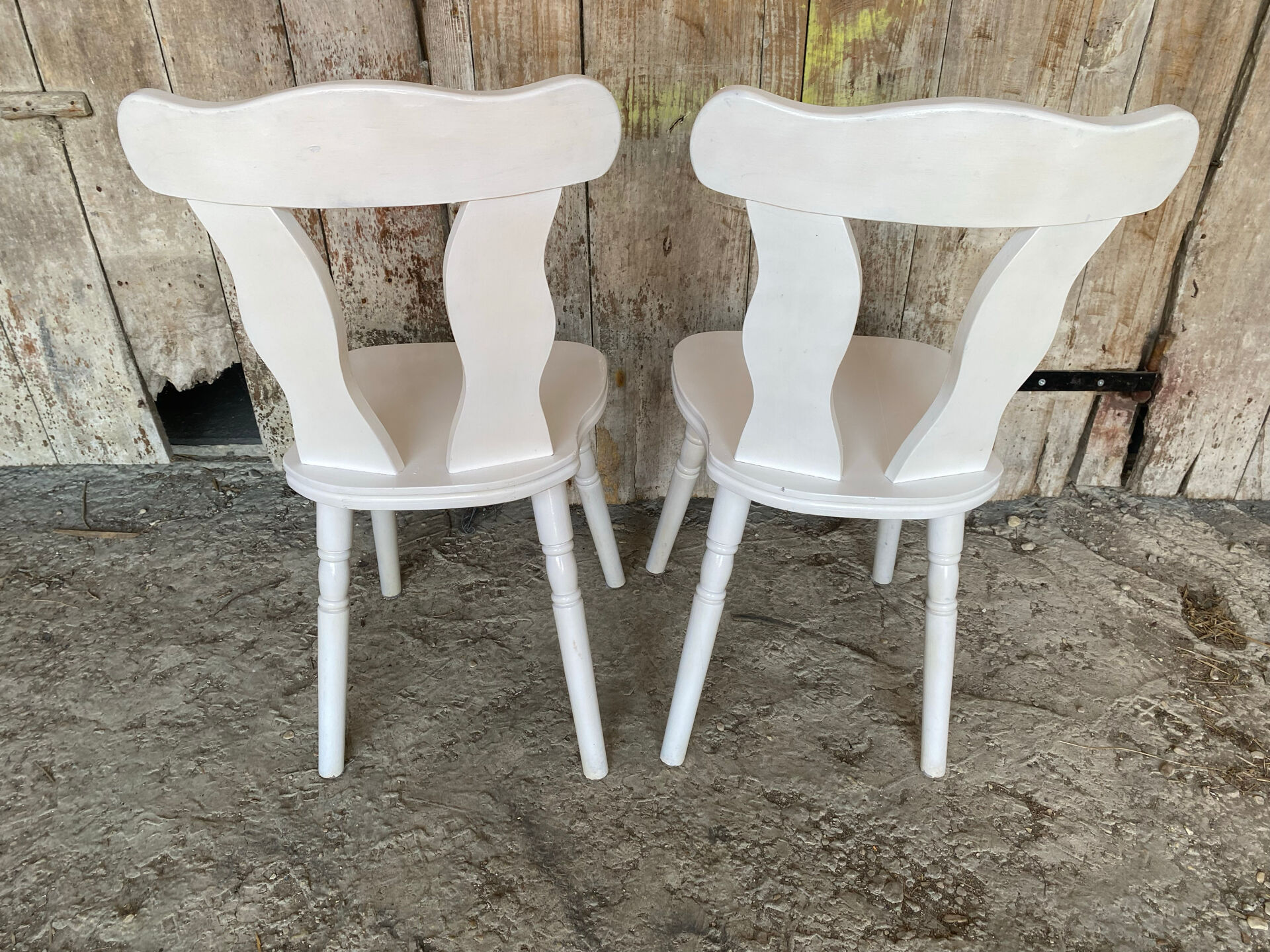 Pair of vintage white wooden bistro chairs