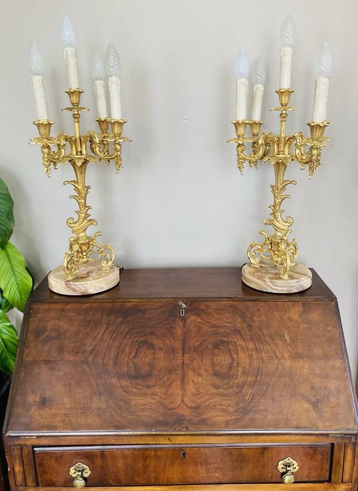 Pair of gilt bronze chandeliers, marble bases.