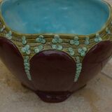 Old earthenware cachepot with flower decoration